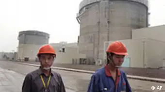 ** FILE** Workers walk past a part of Qinshan No. 2 Nuclear Power Plant, China's first self-designed and self-built national commercial nuclear power plant in Qinshan, about 125 kilometers (about 90 miles) southwest of Shanghai, China shown in this June 10, 2005 file photo. Chinese scientists have built a full superconducting experimental nuclear fusion device meant to replicate the energy created by the sun, with tests to begin in July or August, state media reported Friday, June 2, 2006. (AP Photo/Eugene Hoshiko, file)