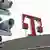 Surveillance cameras next to Telekom logo on roof of building