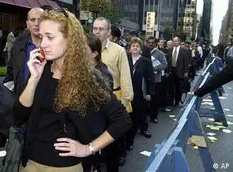 Anne Massey of Manhattan talks on her cell phone while waiting on line with thousands of job seekers attending the Twin Towers Job Expo in New York Thursday Oct. 25, 2001. Massey, who is unemployed, worked at the World Trade Center, which was destroyed in the Sept. 11 terrorist attacks. (AP Photo/Matt Moyer)