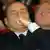 Berlusconi listens with his eyes closed