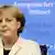 German Chancellor Angela Merkel listens to questions during a media conference after an EU summit
