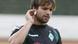 Man in soccer uniform scratching ear Man in soccer uniform scratching ear