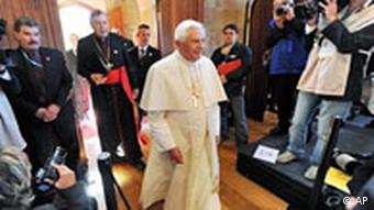 Pope Benedict XVI walks past waiting media for an inter-faith meeting during World Youth Day festivities, in Sydney, Australia