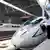 Chinese railway employees cleans the new high-speed CRH3 train as its arrived at the Tianjin Railway Station, China, during a trial run on the new Beijing-Tianjin line, Tuesday, July 22, 2008. A new high speed train link between Beijing and Tianjin, where Olympic soccer matches will be played, is scheduled to open on Aug 1. The train, which can run at speeds up to 350 kph, will cut the travel time between the two Olympic cities from 1 hour, 10 minutes to 25-30 minutes. (AP Photo/Andy Wong)