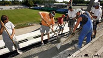 Fans working a stadium building site