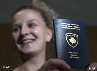 A Kosovo Albanian woman shows her new passport