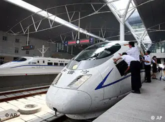 Chinese railway employees cleans the new high-speed CRH3 train as its arrived at the Tianjin Railway Station, China, during a trial run on the new Beijing-Tianjin line, Tuesday, July 22, 2008. A new high speed train link between Beijing and Tianjin, where Olympic soccer matches will be played, is scheduled to open on Aug 1. The train, which can run at speeds up to 350 kph, will cut the travel time between the two Olympic cities from 1 hour, 10 minutes to 25-30 minutes. (AP Photo/Andy Wong)