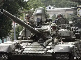 Georgian troops sitting on a tank