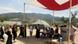 People lining up outside a Red Cross refugee camp People lining up outside a Red Cross refugee camp