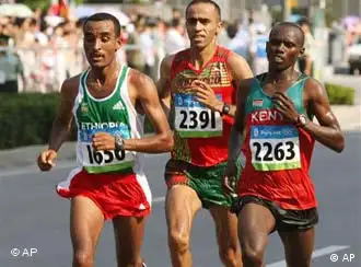 Kenya's Samuel Kamau Wansiru Ethiopia's Deriba Merga (1650), Morocco's Jaouad Gharib (2391) and Kenya's Samuel Kamau Wansiru (2263) compete in the men's marathon during the 2008 Beijing Olympic Games Sunday Aug. 24, 2008. Wansiru won the men's marathon title, giving Kenya their first ever Olympic gold in the event. Gharib finished second for the silver. (AP Photo/Carl de Souza, Pool)