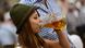 A young woman wearing traditional Bavarian dress enjoys a beer during the Oktoberfest beer festival in Munich in 2012 A young woman wearing traditional Bavarian dress enjoys a beer during the Oktoberfest beer festival in Munich in 2012