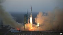 In this photo provided by China's Xinhua News Agency, the Long March-2F carrier rocket carrying China's Shenzhou 11 spacecraft blasts off from the launch pad at the Jiuquan Satellite Launch Center in Jiuquan, northwest China's Gansu Province, Monday, Oct. 17, 2016. China has launched a pair of astronauts into space on a mission to dock with an experimental space station and remain aboard for 30 days. (Li Gang/Xinhua via AP)