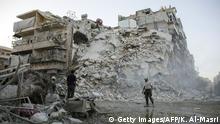 Members of the Syrian Civil Defence, known as the White Helmets, search for victims amid the rubble of a destroyed building following reported air strikes in the rebel-held Qatarji neighbourhood of the northern city of Aleppo, on October 17, 2016. Dozens of civilians were killed as air strikes hammered rebel-held parts of Aleppo early morning, despite Western warnings of potential sanctions against Syria and Russia over attacks on the city. Both Russian and Syrian warplanes are carrying out air strikes over Aleppo in support of a major offensive by regime forces to capture rebel-held parts of the northern city. / AFP / KARAM AL-MASRI 