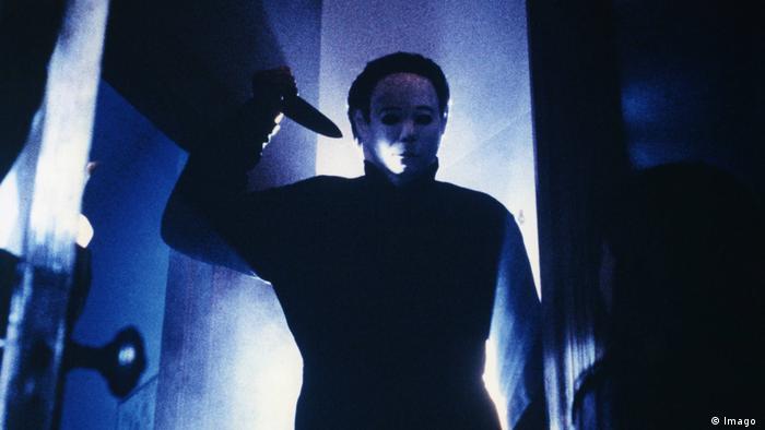 photo from the film Halloween, character holding a knife, bluish light