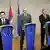 Serbia's Deputy Prime Minister Bozidar Djelic, left, along with Serbia's President Boris Tadic, center, and European Union Commissioner for Enlargement Olli Rehn, right at podium with EU flag of yellow stars against royal blue background