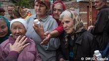 Title:
Reliance on humanitarian aid
Caption:
Women line up to receive medicine and multivitamins in Zhovanka. Food and humanitarian supplies are delivered to the town by charity organizations, as crossing checkpoints sometimes require people to wait more than a day in line. “We had everything, we had fresh air, nature. It was very nice here. Now we just have the cold,” said local resident Vera Sharovarova.
Ukrainian civilians living near the frontline
Under nightly mortar fire, thousands of elderly and impoverished civilians continue living on the front lines and in between them in East Ukraine’s ‘gray zone.’ Diego Cupolo reports from Donetsk.
Foto: Diego Cupolo, DW, Ukraine, Oct 2016