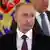 Headshot of Putin in the foreground, with Lavrov and a Russian flag just behind him, both out of focus.