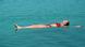 Seorang perempuan yang tengah mengapung di Laut Mati Seorang perempuan yang tengah mengapung di Laut Mati