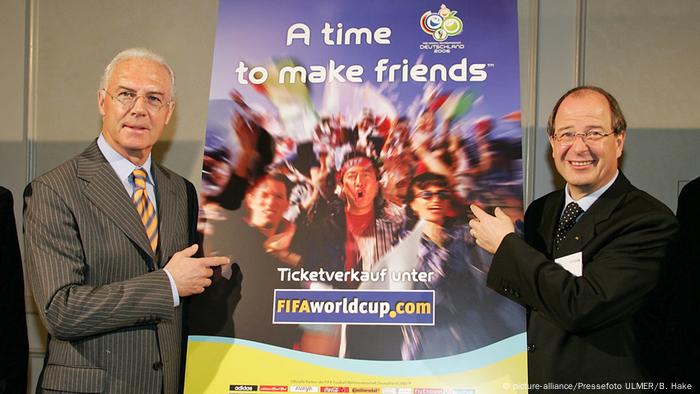 Beckenbauer and Linsi hold 2006 World Cup poster Beckenbauer and Linsi hold 2006 World Cup poster