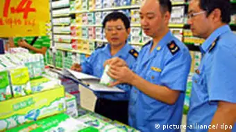 Chinese law enforcement officers check milk manufactured by Mengniu at a supermarket in Nanchong city, southwest Chinas Sichuan province, 19 September 2008.China ordered widespread checks on dairy products and a recall of tainted items as a milk scandal that began with powdered baby formula spread to liquid milk and sparked an outcry from Chinas trading partners. Foto: Liu Hai +++(c) dpa - Report+++