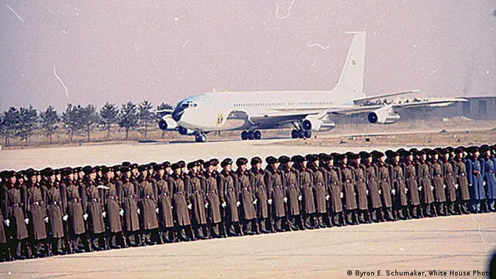 From the 1960s onward, jet technology allowed for regular face-to-face meetings with world leaders. In 1972, Nixon became the first president to visit China with Special Air Mission (SAM) 26000, a Boeing 707. It was first lady Jackie Kennedy who ordered Air Force One's now iconic trademarks: a bold blue and bright white, UNITED STATES OF AMERICA across the fuselage and a US flag on the tail.
