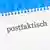 Разлинованный лист бумаги из блокнота, на котором написано слово "postfaktisch"