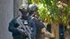 The elite Indonesian police commando belonging to Densus 88 raids a house The elite Indonesian police commando belonging to Densus 88 raids a house