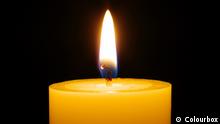  burning candle isolated on black background
