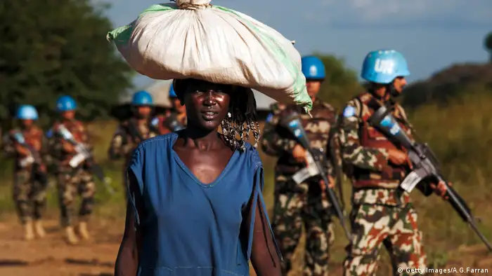 Woman walks past UN soldiers in South Sudan. (Getty Images/A.G.Farran)