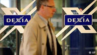 A man is seen at a branch of the Dexia bank