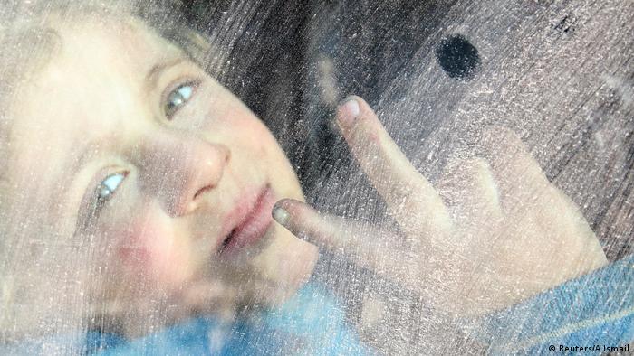Ein kleiner Junge in einem Bus, der Zivilisten aus Ost-Aleppo wegbringt