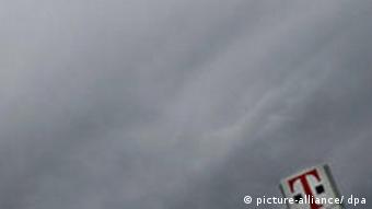 Deutsche Telekom sign against a dark, cloudy sky