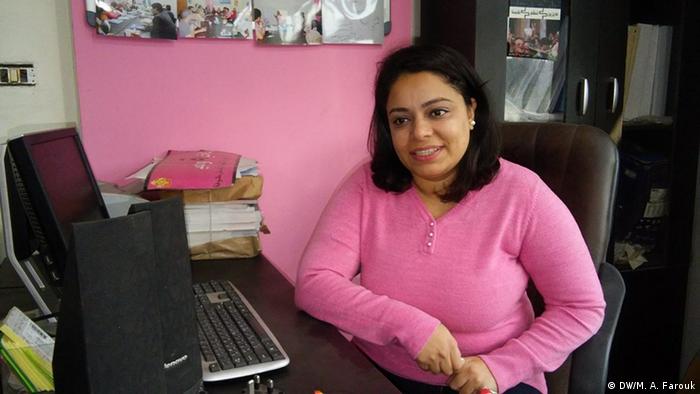 Nemaa Gamal sits at a table at the NGO that helped her sue her harasser