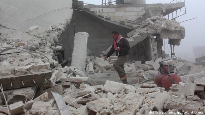 Man walks through rubble in Aleppo