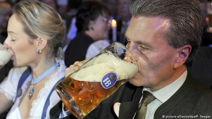 Günther Oettinger drinks a tankard of beer