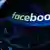 Логотип Facebook на фоне клавиатуры компьютера