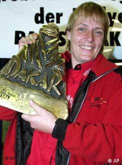 A proud moment - Jutta Kleinschmidt shows off her trophy after winning the Paris-Dakar rally in January, 2001.