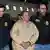 El Chapo arriving in New York between two law enforcement officers