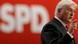 Frank-Walter Steinmeier speaks in front of an SPD sign Frank-Walter Steinmeier speaks in front of an SPD sign