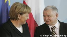 BERLIN - OCTOBER 30: German Chancellor Angela Merkel and Polish Prime Minister Jaroslav Kaczynski leave a news conference at the Chancellery after talks October 30, 2006 in Berlin, Germany. German-Polish relations have been strained in recent months, particularly over a planned German-Russian natural gas pipeline in the Baltic Sea that will bypass Polish territory. (Photo by Sean Gallup/Getty Images)