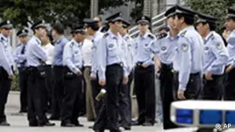 Policemen stand in the grounds of the Shanghai Higher People's Court after the appeal of man convicted of killing six policemen ended Monday Oct. 20, 2008. Dozens of Chinese gathered outside the court as Yang Jia appealed his death sentence for killing six policemen in a stabbing spree in July. Yang, who drew a surprising amount of sympathy in China after being accused of the killings, will get the death penalty after losing his final appeal Monday.(AP Photo/Greg Baker)
