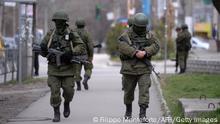 Russian soldiers patrol outside the navy headquarters in Simferopol on March 19, 2014. Russia's Constitutional Court unanimously ruled on March 19, 2014 that President Vladimir Putin acted legally by signing a treaty to make Crimea part of Russia, in an essential step in the Russian legal process towards ratifying the treaty. AFP PHOTO/ Filippo MONTEFORTE (Photo credit should read FILIPPO MONTEFORTE/AFP/Getty Images)