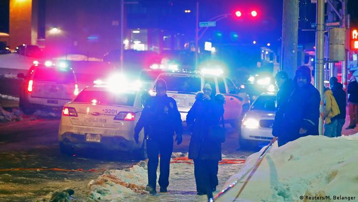 Police officers are seen near a mosque after a shooting in Quebec City, Canada (Reuters/M. Belanger)