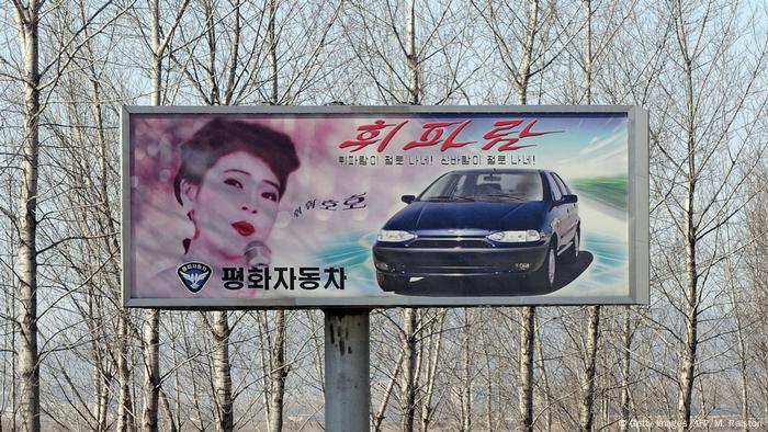 An advertising billboard promoting the North Korean made Pyeonghwa brand car is pictured outside the North Korea capital Pyongyang