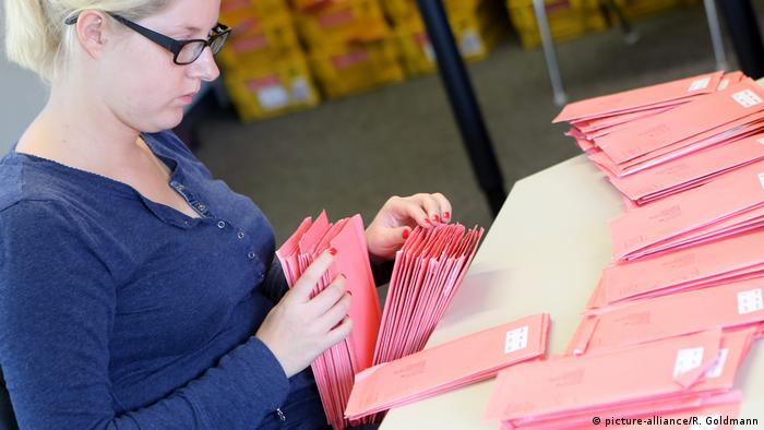 A poll worker counting envelopes with mail-in ballots during a 2013 election in Cologne, Germany
