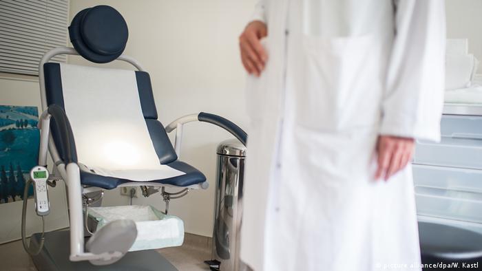 A doctor stands in an examination room at a hospital in Berlin