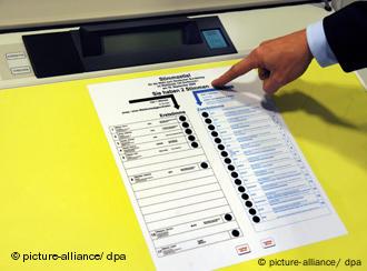 Person pointing at an electronic voting machine