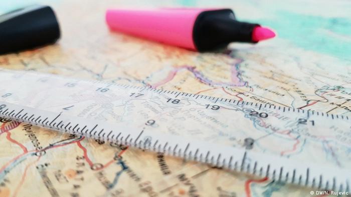 A map with a ruler and writing utensils