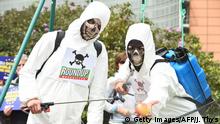 Members of Avaaz civic organization dress as crop-sprayers on May 18, 2016 at the Schuman roundabout in Brussels, in protest at the European Commissions' plans to relicense glyphosate, the controversial, carcinogenic weed-killer. / AFP / JOHN THYS (Photo credit should read JOHN THYS/AFP/Getty Images)