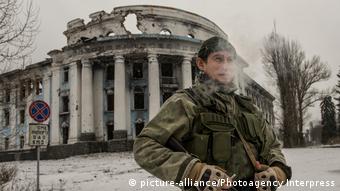 Человек с оружием у здания в Донецке